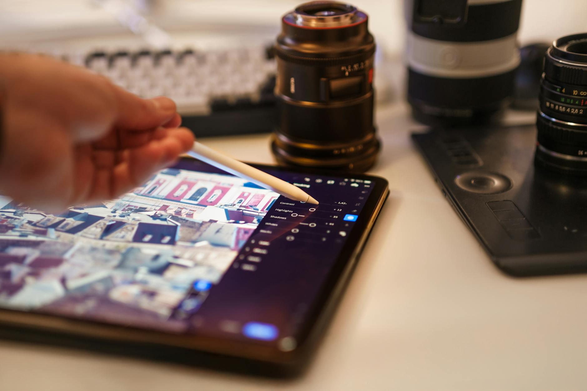 Professional photographer working on photo editing in Adobe Lightroom with color grading panels and adjustment tools visible on screen